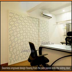 Seamless engraved design flowing from the side panels onto the sliding door